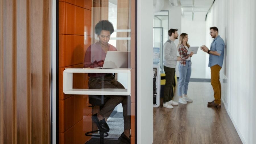 Female Employee Working From Office Booth